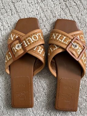 Christian Louboutin Crossimule leather slides in a tan brown woven design.